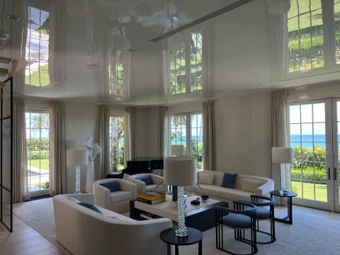 A residential living room with a high gloss ceiling finish