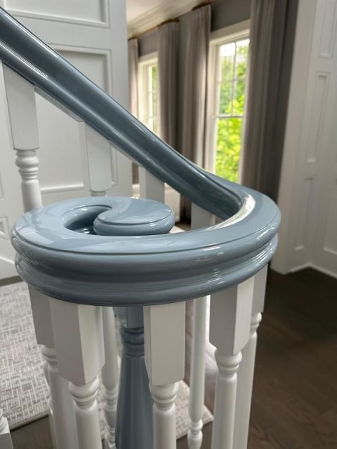 A residential staircase railing painted with high gloss paint