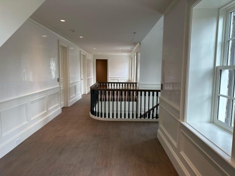 A hallway and staircase painted with high gloss paint in a residential home